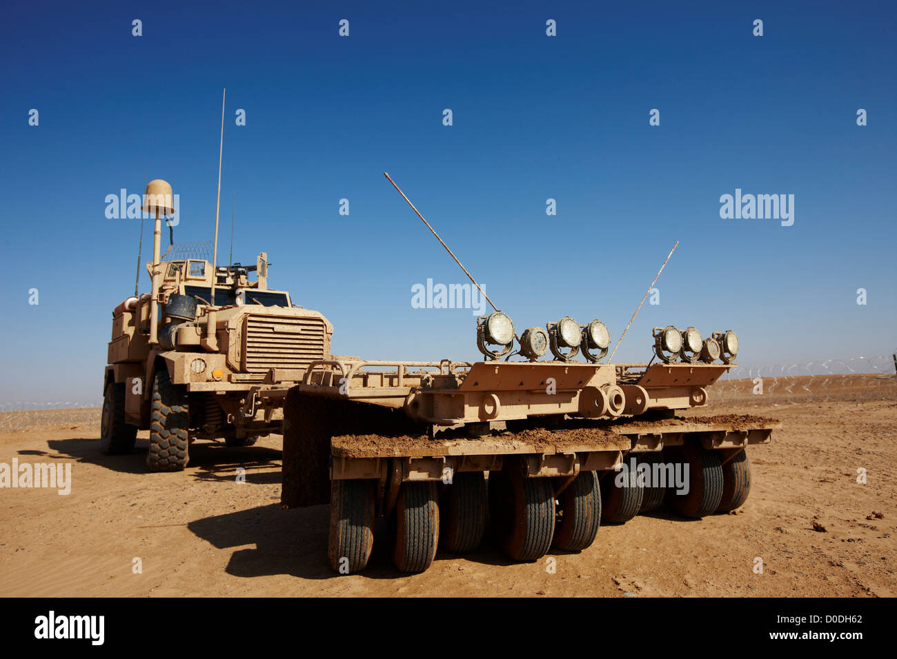 MRAP or mine resistant ambush protected vehicle fitted mine roller remote  austere United States Marine Corps combat outpost in Stock Photo - Alamy