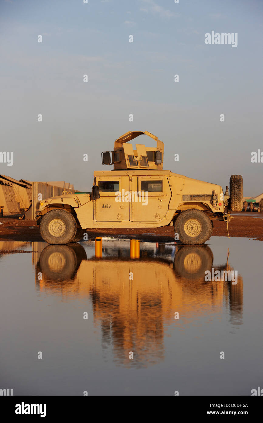 HMMW, or Humvee, parked on a puddle in Afghanistan's Helmand Province Stock Photo