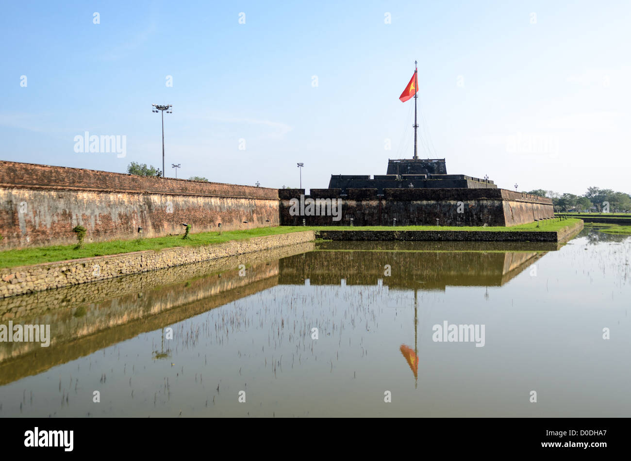 HUE, Vietnam — The citadel and moat at the Imperial City in Hue, Vietnam. A self-enclosed and fortified palace, the complex includes the Purple Forbidden City, which was the inner sanctum of the imperial household, as well as temples, courtyards, gardens, and other buildings. Much of the Imperial City was damaged or destroyed during the Vietnam War. It is now designated as a UNESCO World Heritage site. Stock Photo