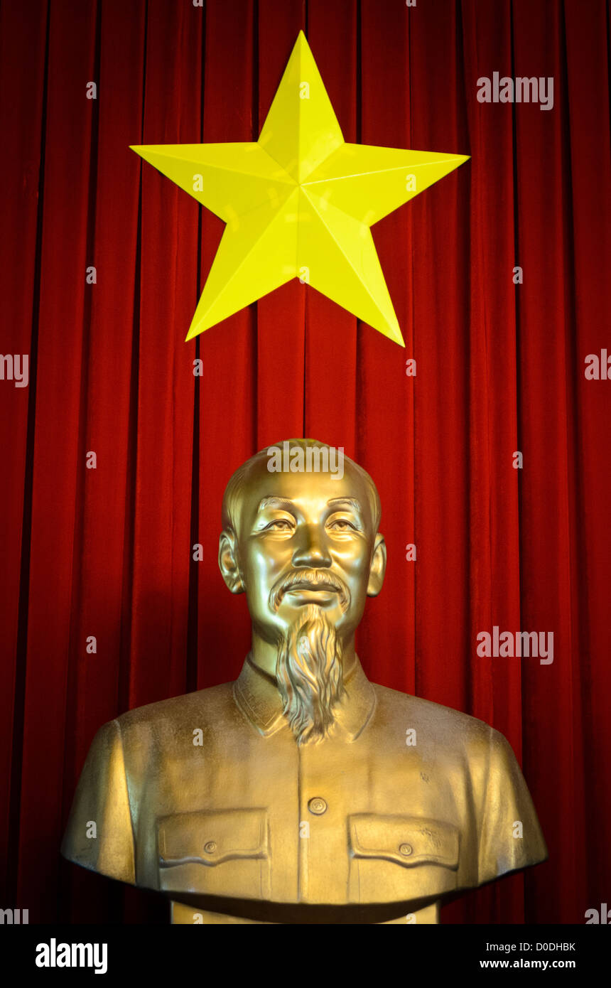 HO CHI MINH CITY, Vietnam - A golden statue of Ho Chi Minh, the founding leader of modern Communist Vietnam, with the Vietnamese star against deep red drapes on display in Reunification Palace in Ho Chi Minh City (Saigon), Vietnam. Stock Photo