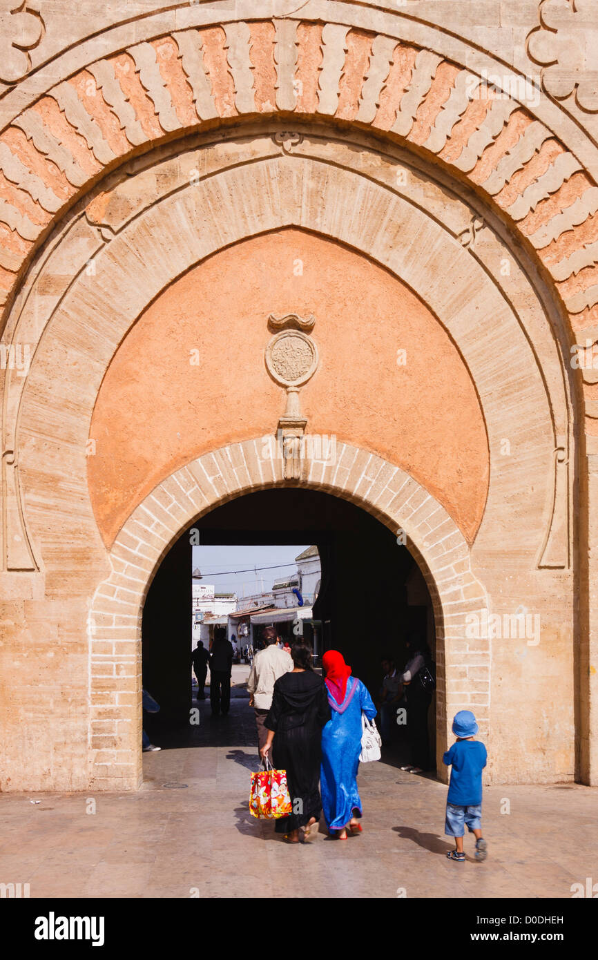 walking through a monumental gateway to the medina of Rabat, Morocco ...