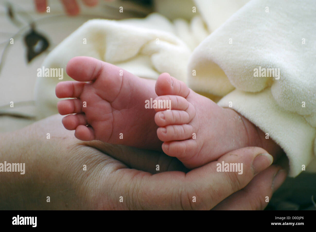 Mother holding her newborn feet Stock Photo