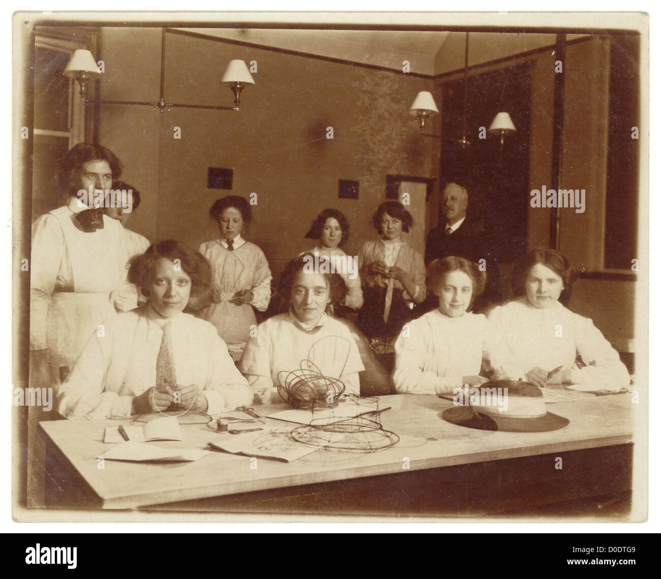 Original WW1 era photograph of young women at a Technical school millinery class, craft crafts crafting, making, designing hats, dated 1915, U.K. Stock Photo