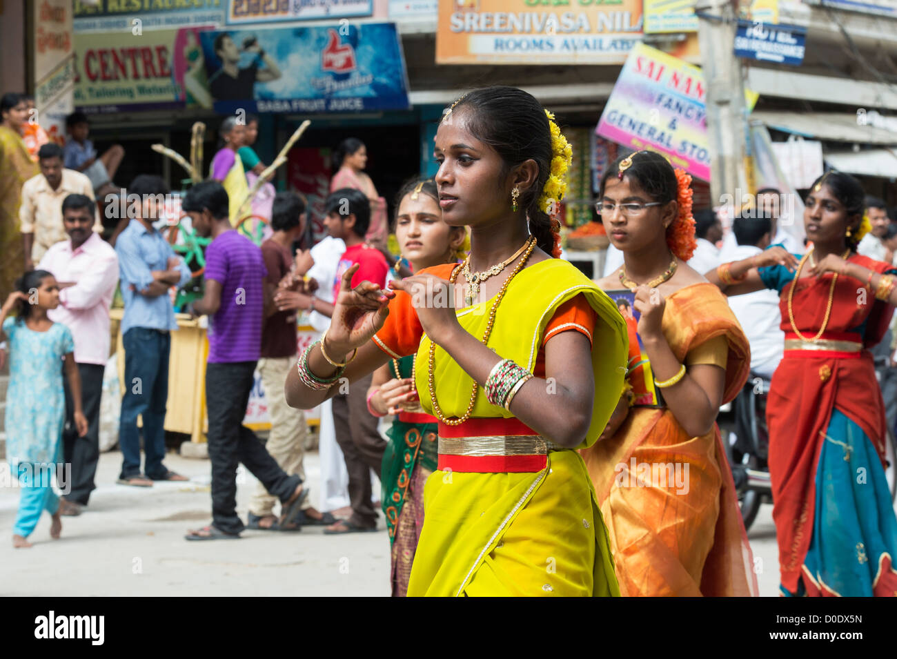 Indian girls in traditional dress dancing at a festival in the streets of Puttaparthi. Andhra Pradesh, India Stock Photo
