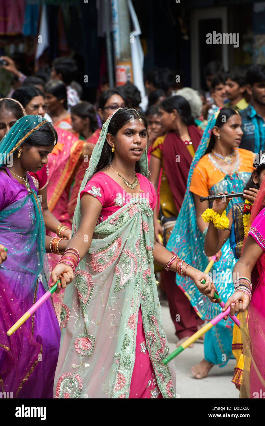 Indian girls in traditional dress dancing at a festival in the streets of Puttaparthi. Andhra Pradesh, India Stock Photo