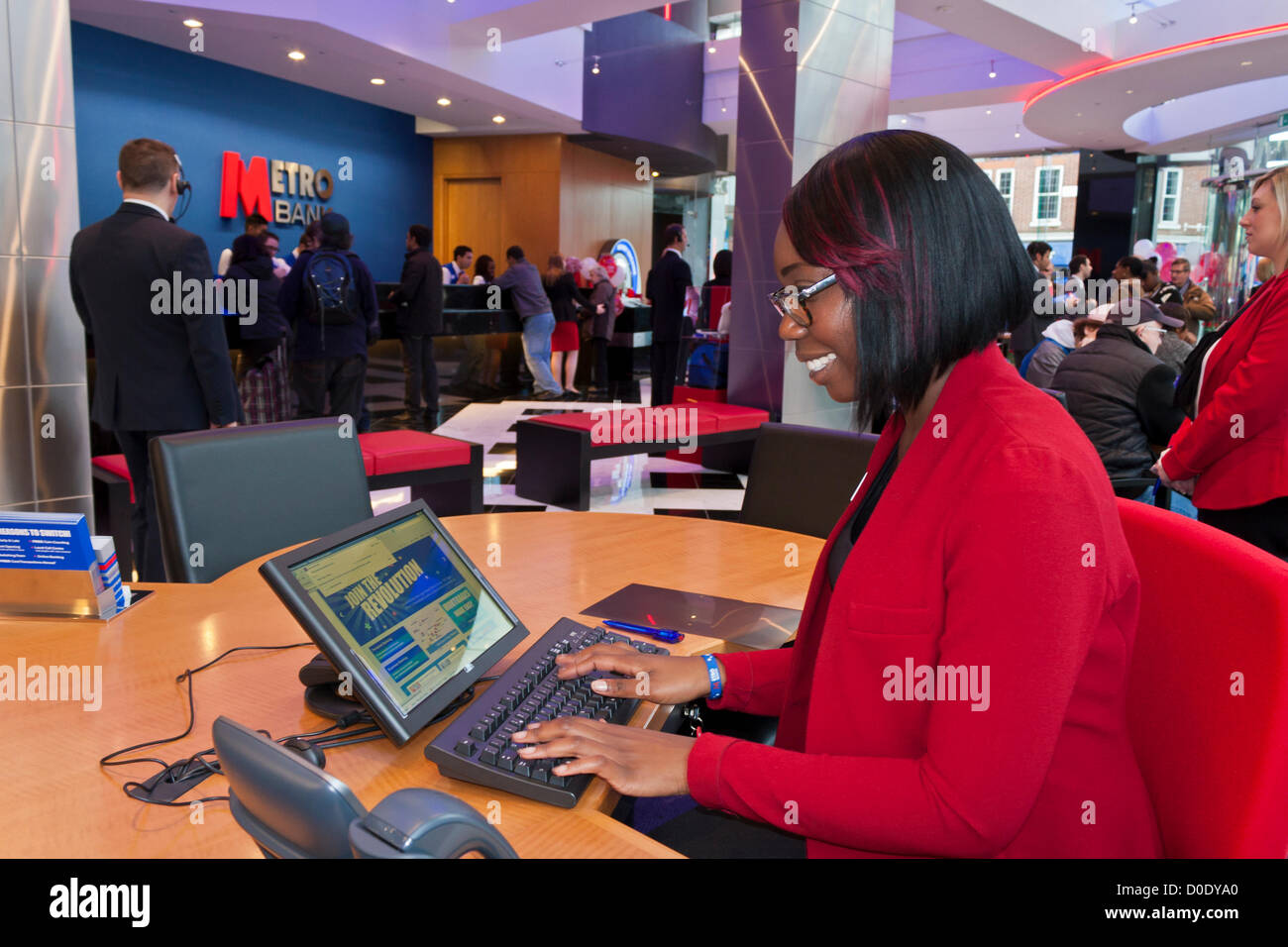A Customer Service Representative at the opening of the new branch of Metro Bank in Reading, Berkshire on November 23rd 2012. Stock Photo