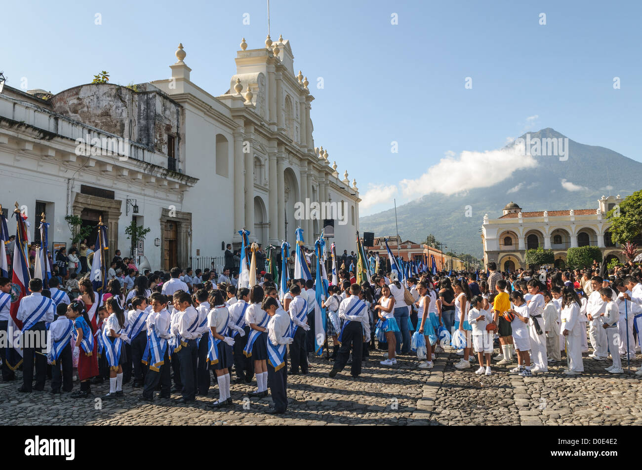 ANTIGUA, Guatemala - During the morning on the day before Guatemalan Independence Day (which is celebrated on September 15), hundreds of school children from Antigua and the surrounding villages march in a parade of school groups in Antigua, some in costumes and others in their school uniforms. The parade includes school marching bands and cheerleaders as well. The procession starts at Parque Central and weaves its way past the bright yellow La Merced church and onto the municipal stadium. Stock Photo
