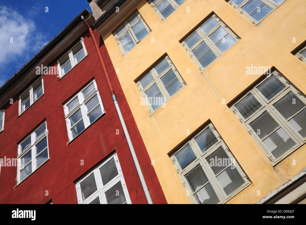Front and windows of old and restored colourful yellow and red blocks of flats in Gråbrødretorv, Graabroedre Square, in central Copenhagen, Denmark Stock Photo