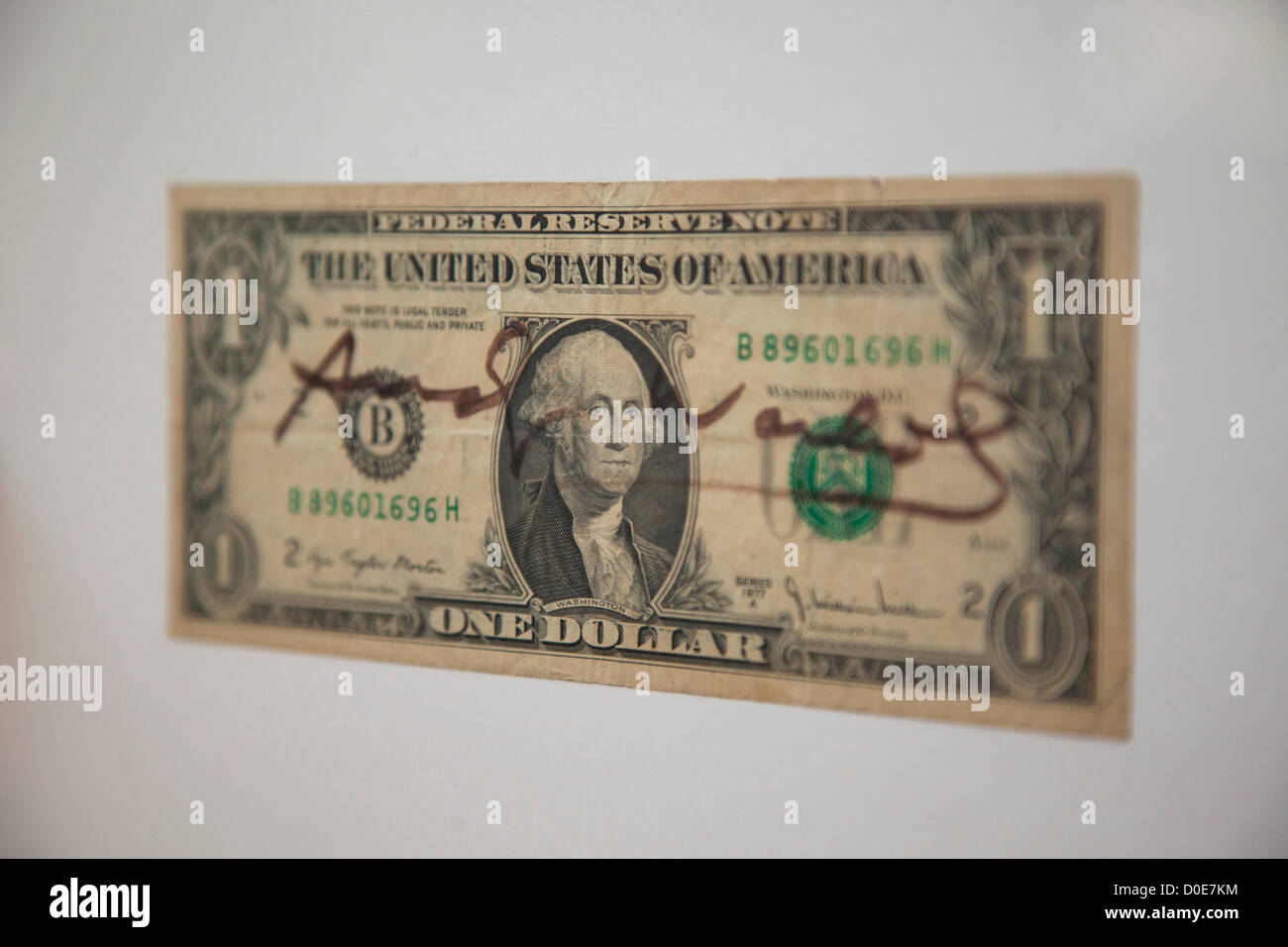 London, UK. Friday 23rd November 2012. Christies auction house showcasing memorabilia from every decade of the past century of popular culture from the industries of film and music. One dollar bill signed by Andy Warhol. Stock Photo