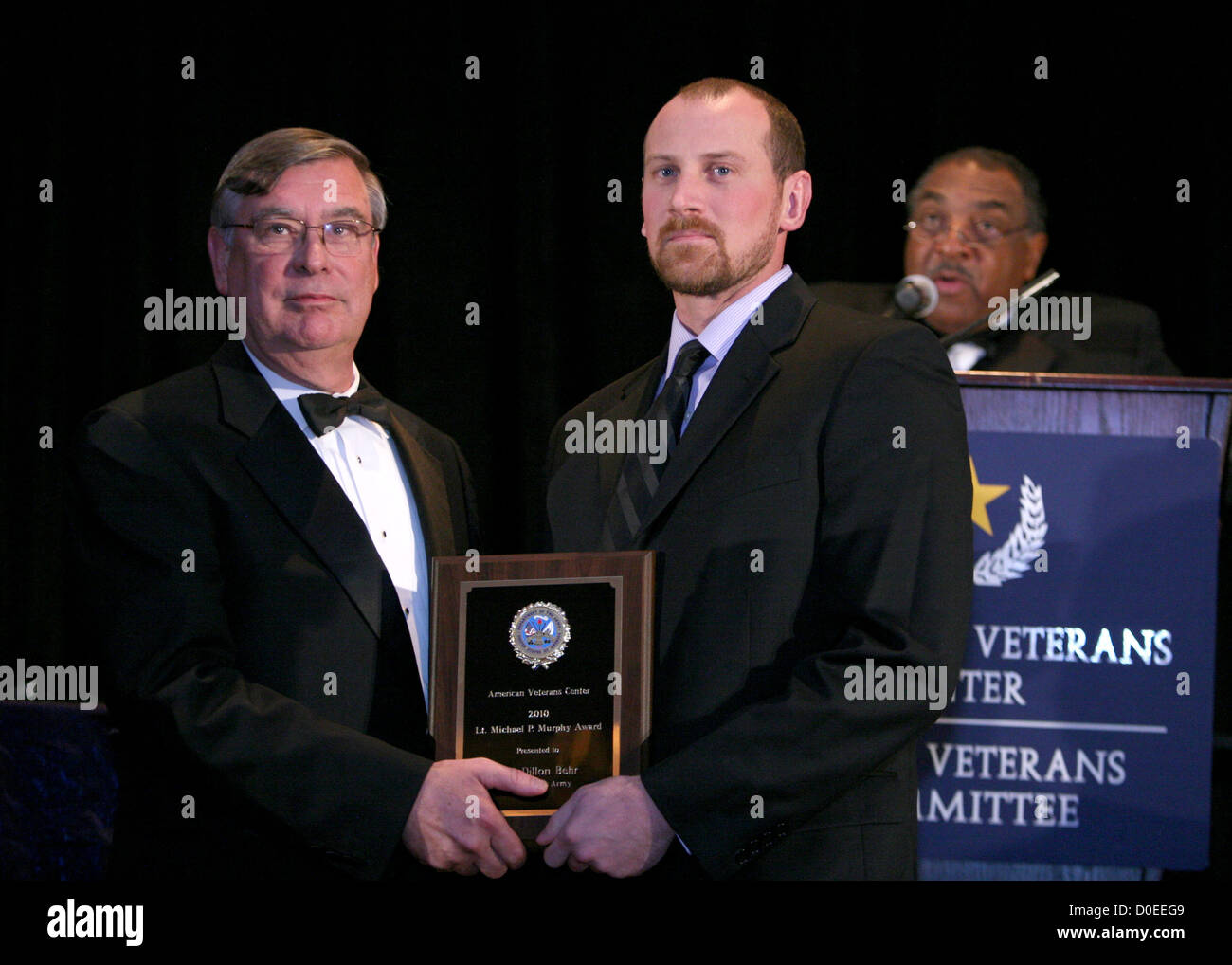 Master of Ceremonies Paul Berry, with SSG Dillon Behr, recipient of the Inauguaral Lt Michael Murphy award Valor in Stock Photo