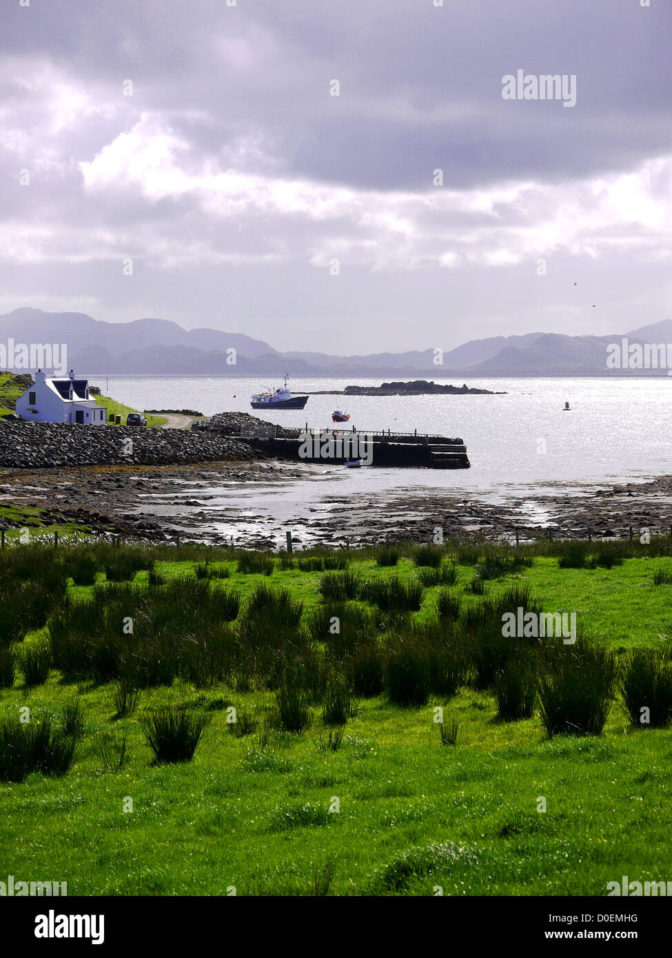 Isle of Muck in the Inner Hebrides Scotland with Ardnamurchan peninsula in the background Stock Photo