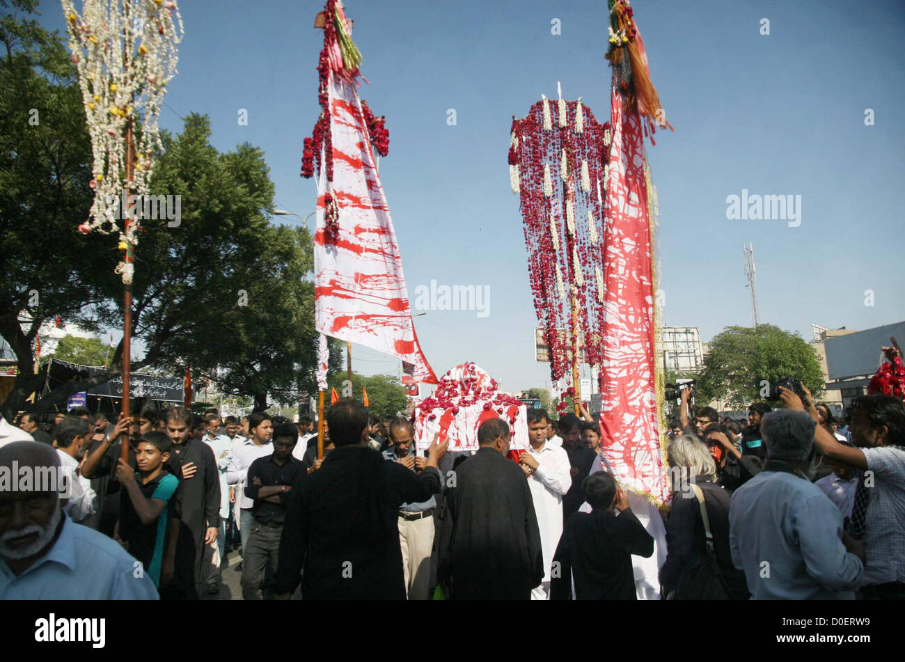 Mourners participate during religious processions in  connection of 8th Moharram-ul-Haram, pass through M.A Jinnah Road in Karachi on Friday,  November 23, 2012. Mourners attend such processions and gathering during the Holy month of  Moharram-ul-Haram in remembrance of Imam Hussain (A.S) grandson of Prophet Muhammad  (PBUH) and his sufferings Stock Photo