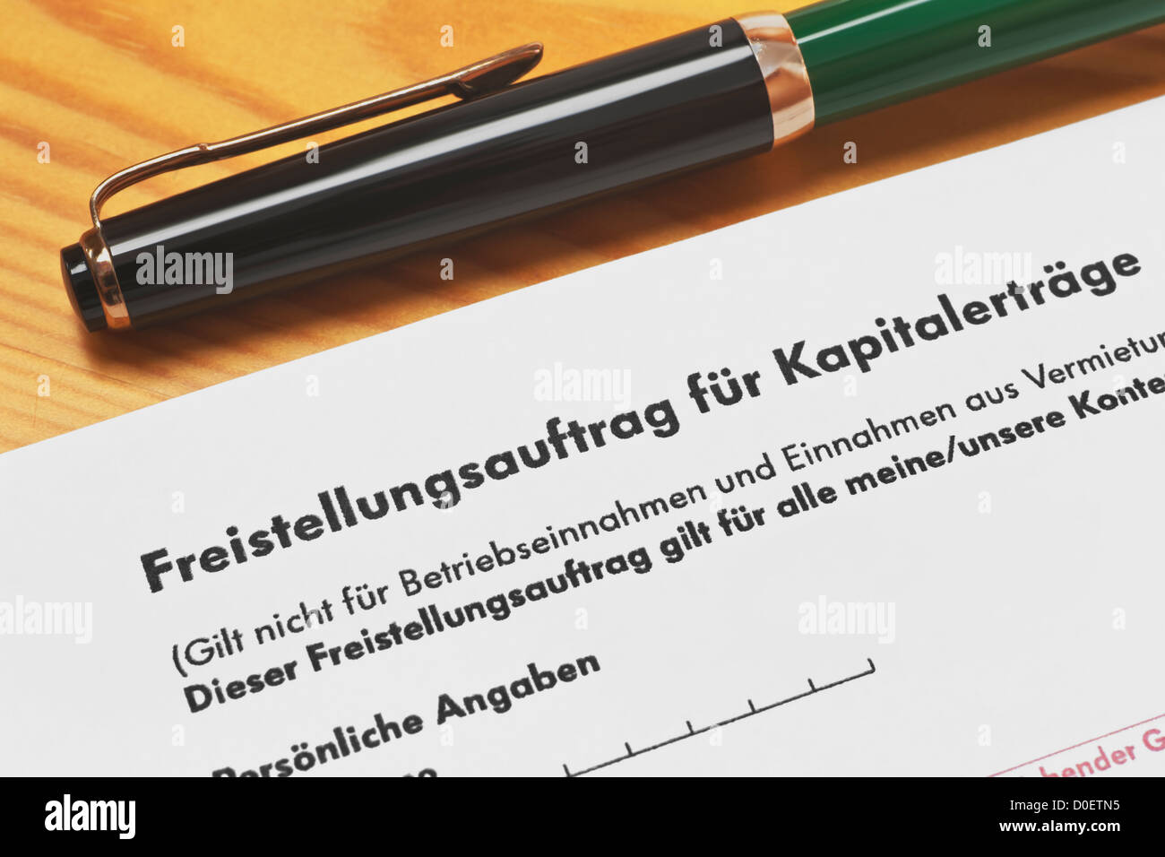 Detail photo of a German form 'exemption order for capital gains', a pen lies alongside Stock Photo
