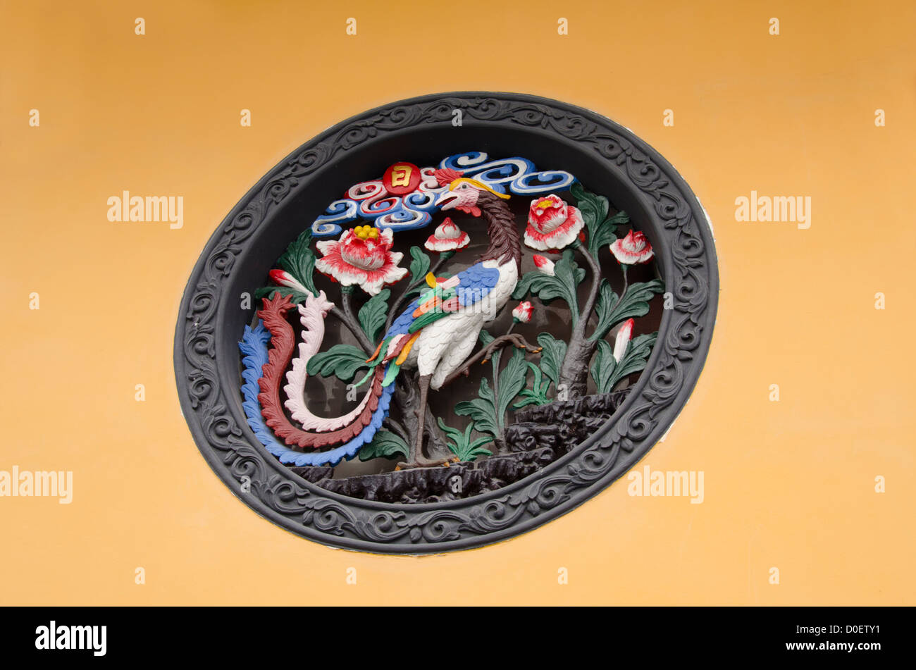 China, Shanghai, Jade Buddha Temple. Wall detail with carved mythical phoenix bird. Stock Photo