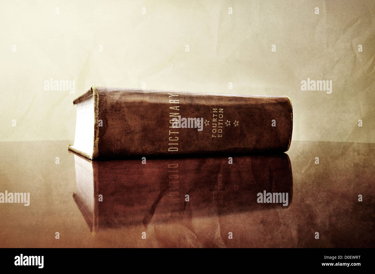 A large old dictionary sitting on a desk Stock Photo