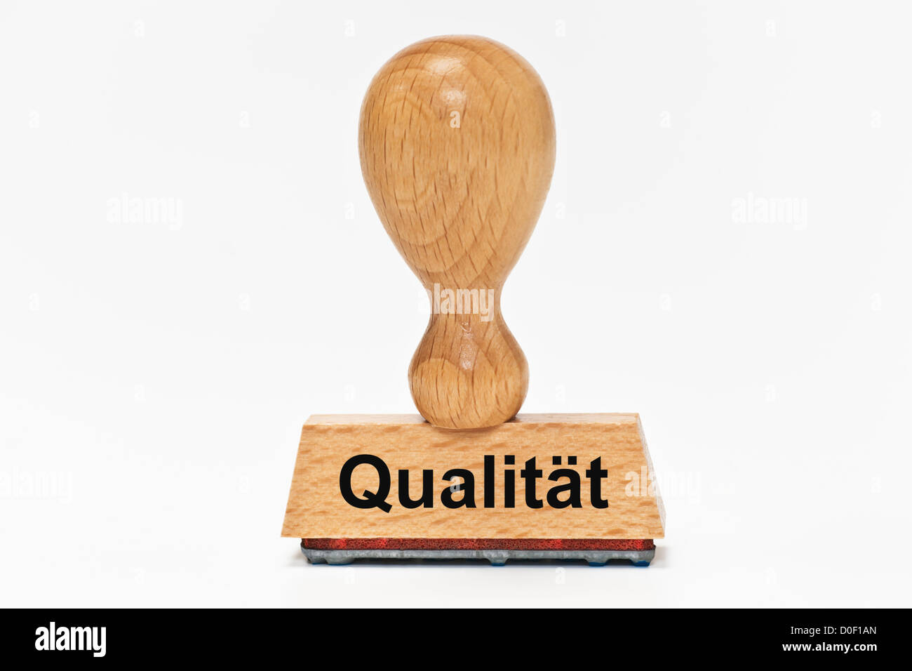 One Stamp with the German inscription Qualität (Quality) upright, background white. Stock Photo