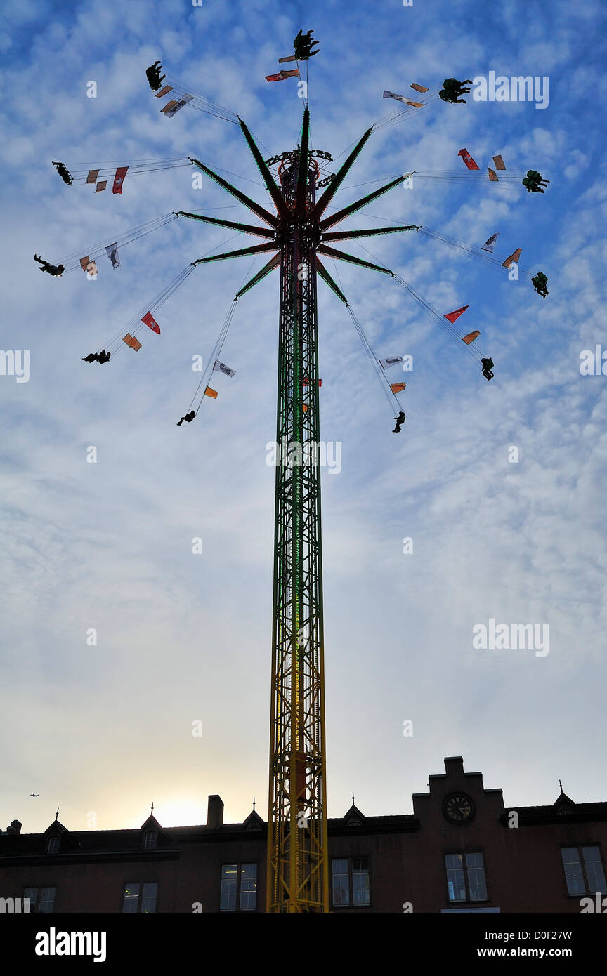 People enjoying a sunny fall afternoon on a amusement park ride at the 2012 Basel Fall Fair. Stock Photo