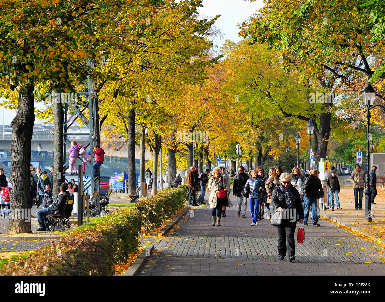 People enjoy a wonderful fall afternoon at the banks of the Rhine river in Basel Switzerland. Stock Photo
