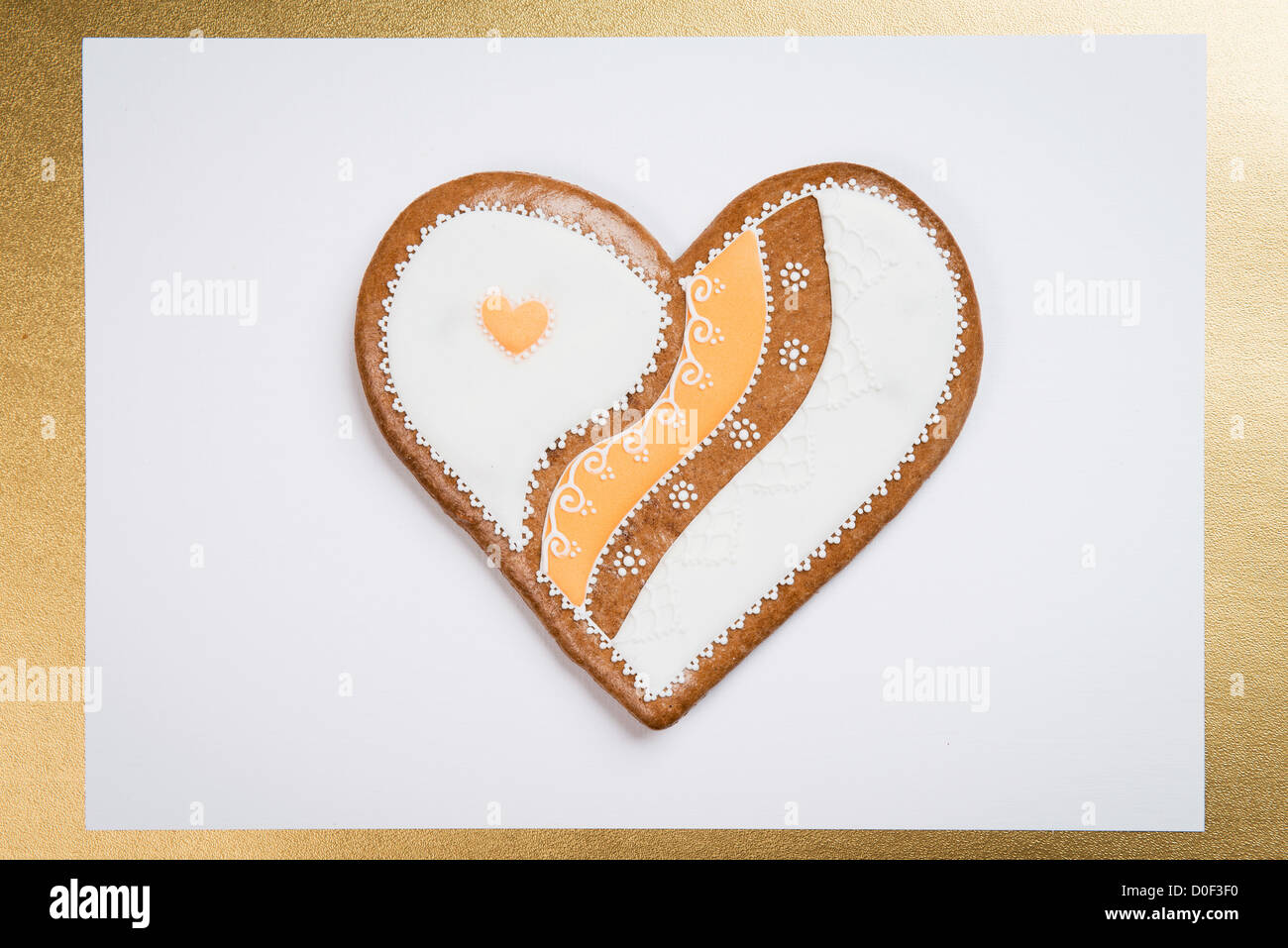 gingerbread cookie heart in golden frame on white background Stock ...