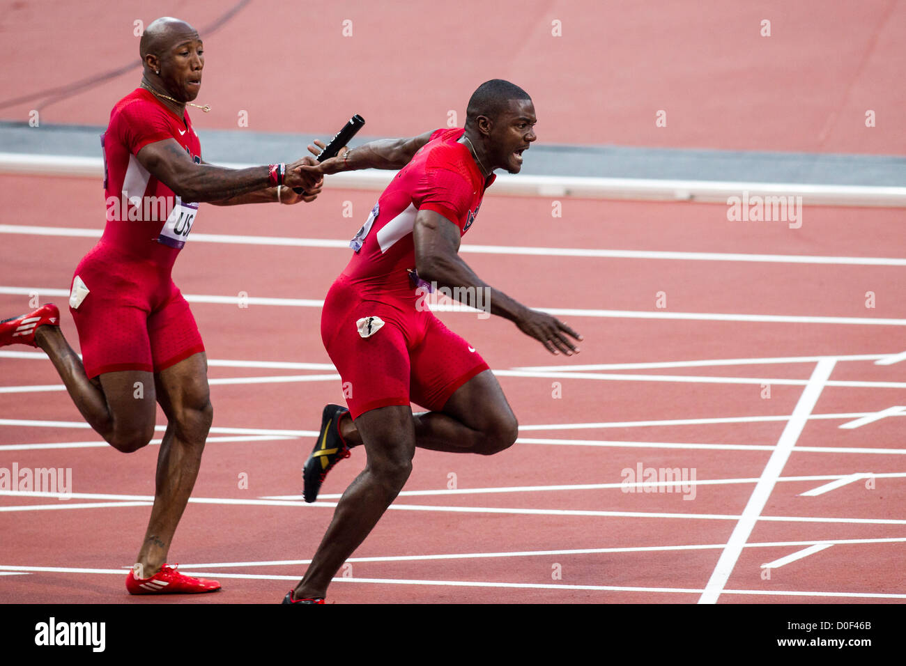 Justin Gatlin takes the baton from USA teammate Trell Kimmons in the final of the 4X100 relay at the Olympic Summer Games, Stock Photo