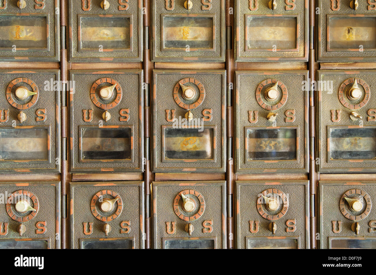 vintage US mail pigeonholes with locked brass doors Stock Photo