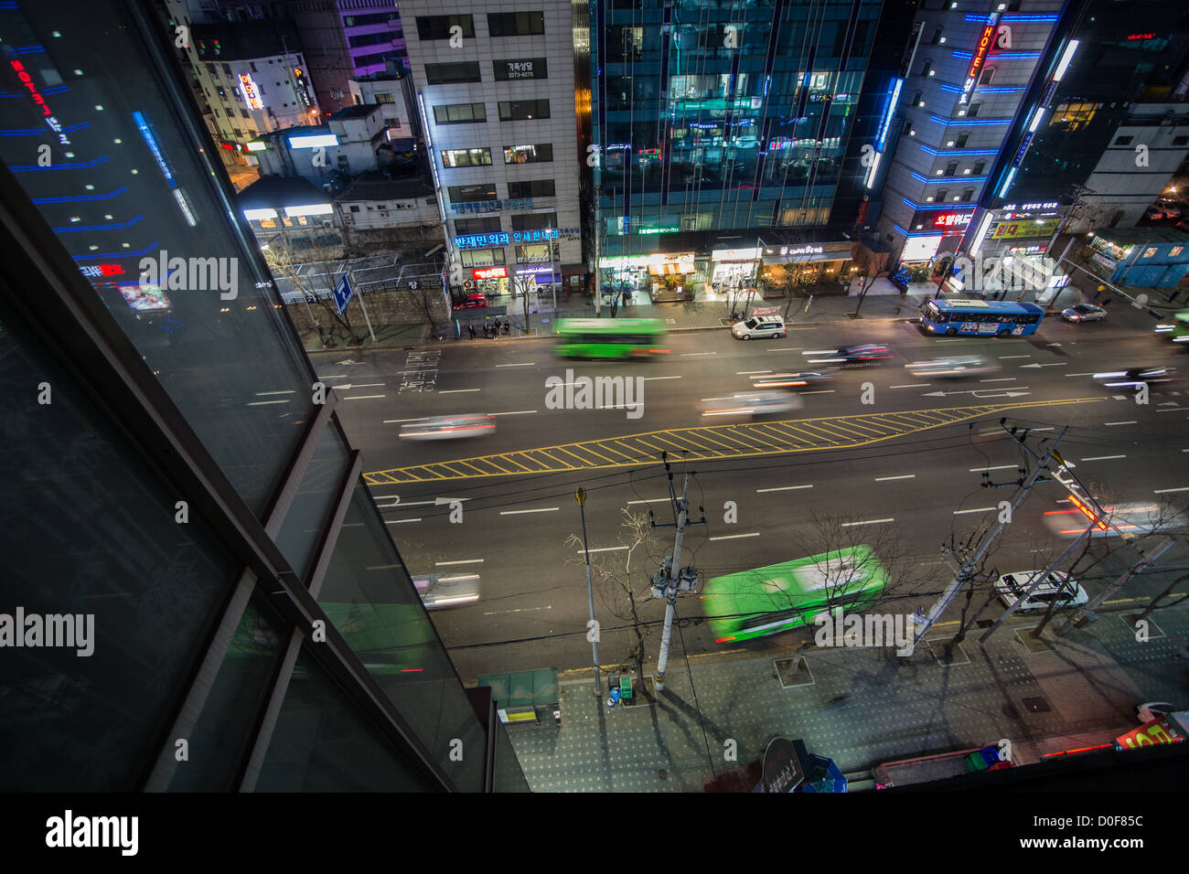Night street scene - cars zooming by in Seoul, Korea Stock Photo