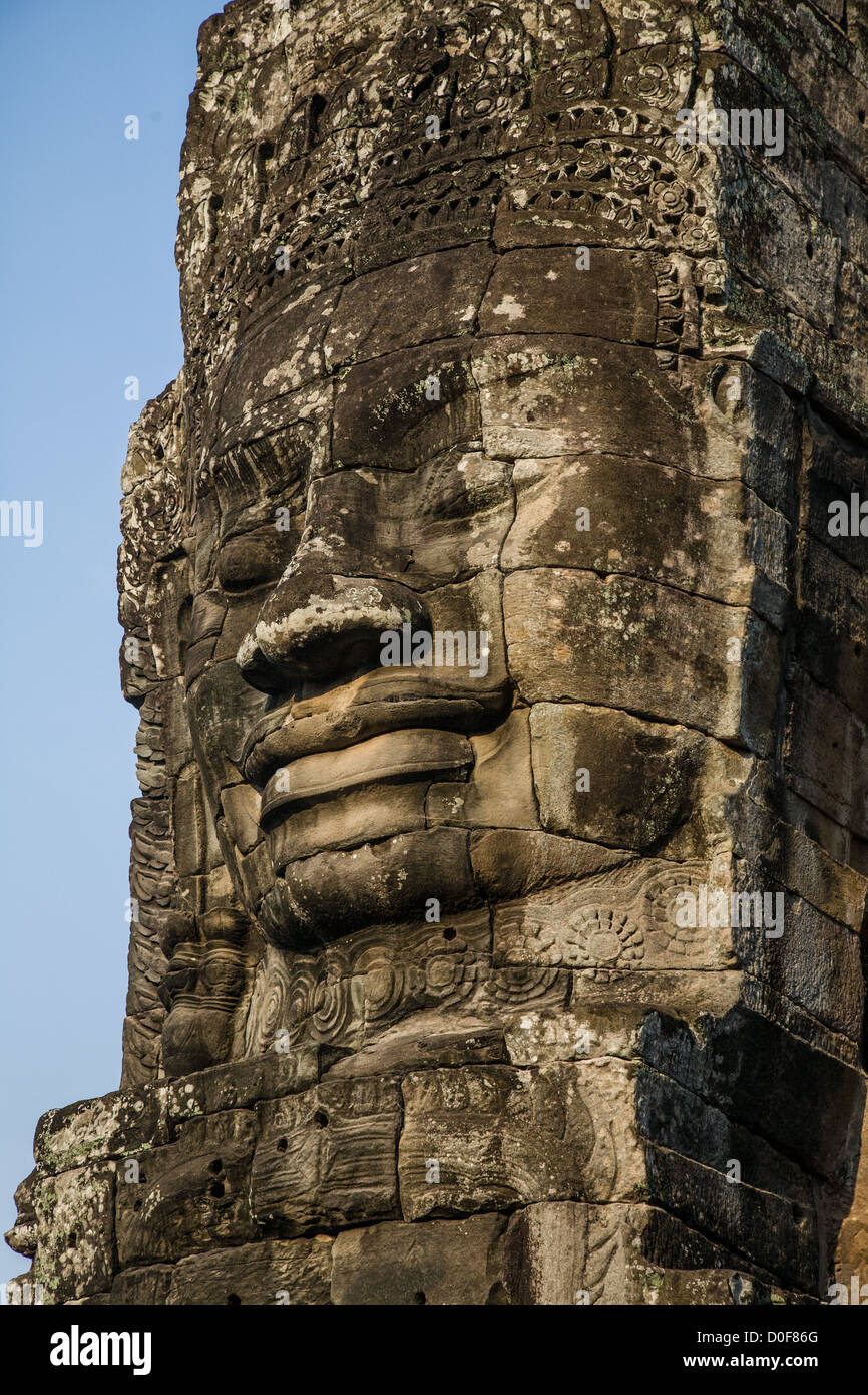 Giant carved stone face at Bayon temple near Angkor Wat in Cambodia Stock Photo