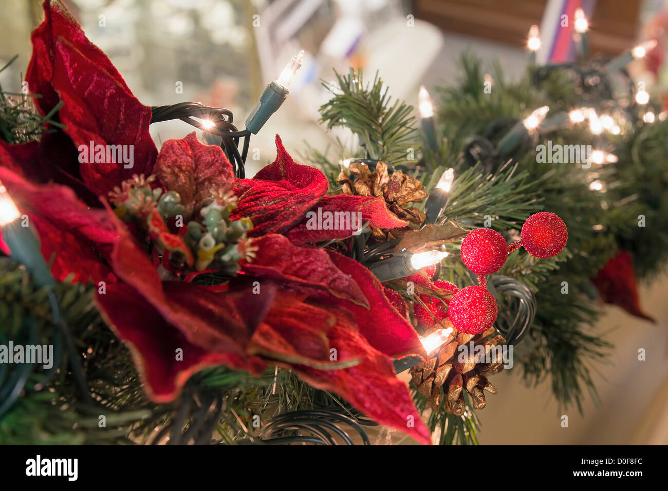 Christmas Decoration Garland with Poinsettia Pine Cones and Lights on Staircase Stock Photo