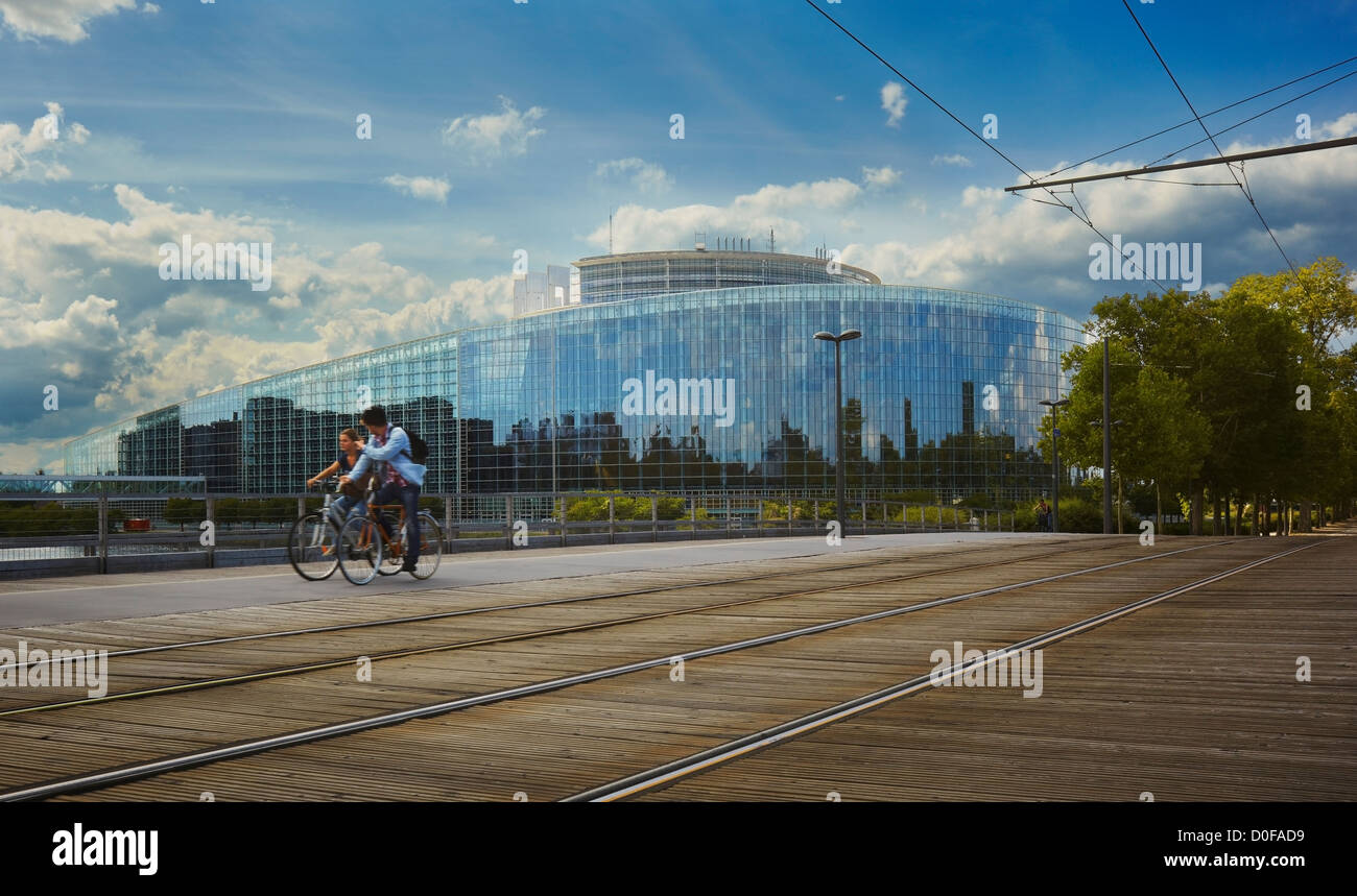 Cyclists passing by the European Parliament seat, Louise Weiss building, Strasbourg, Alsace, France Stock Photo
