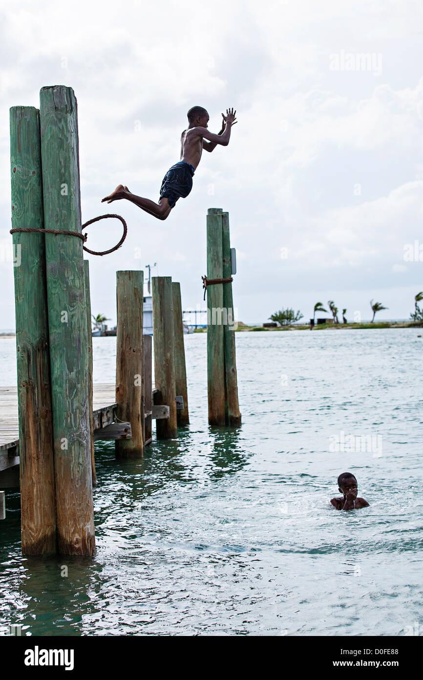 Young boys jump off pier pillions into the New Plymouth Harbour at New