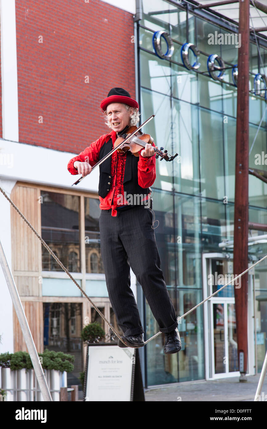 Tight Rope Playing Instruments Street entertainer playing a violin whilst walking on a tight rope ...