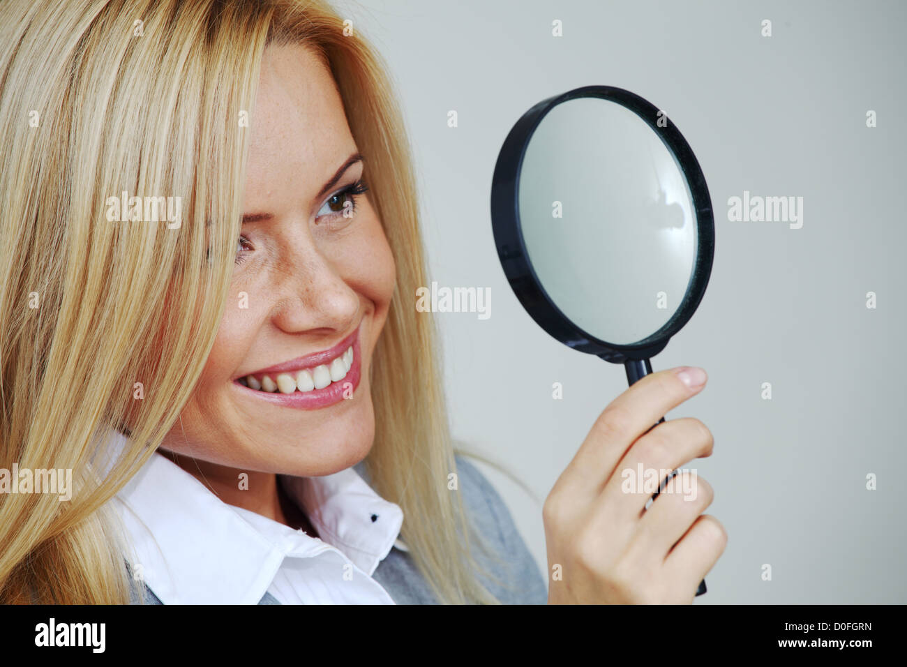 business woman looking through a magnifying glass Stock Photo - Alamy