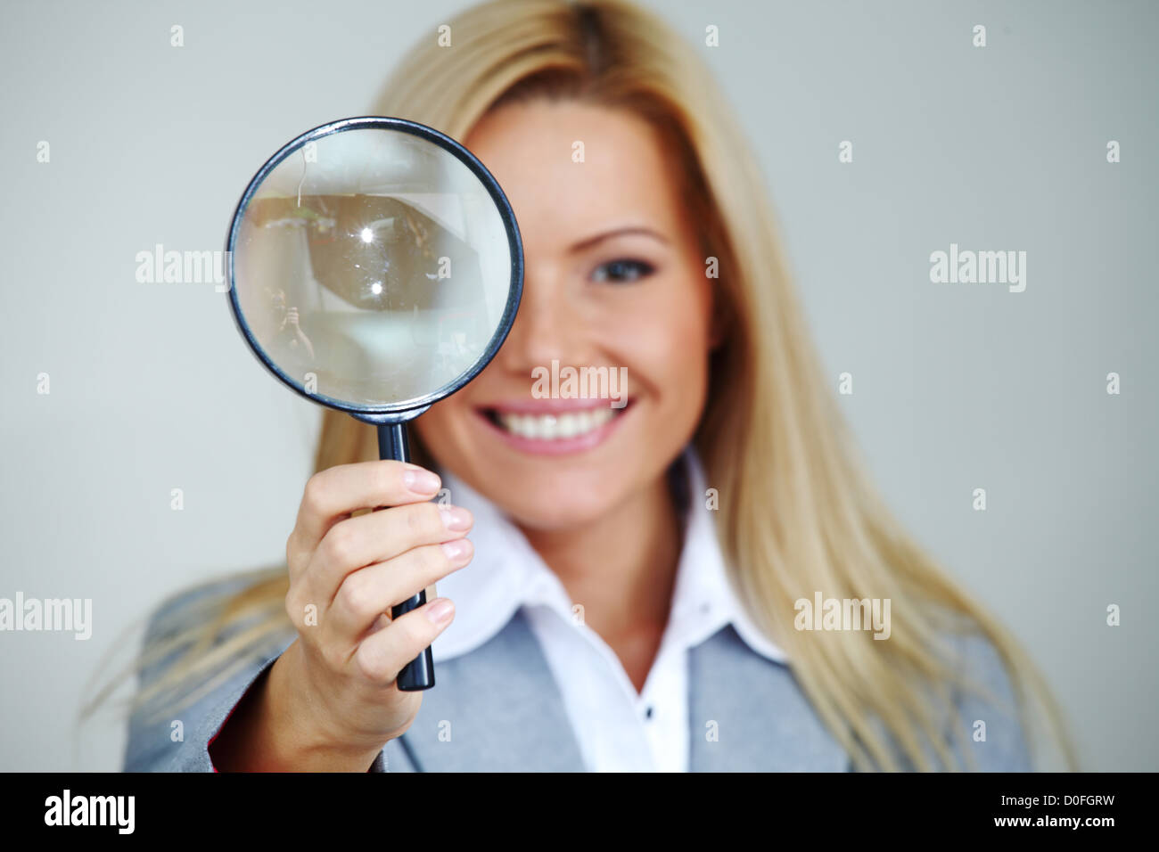 business woman looking through a magnifying glass Stock Photo - Alamy