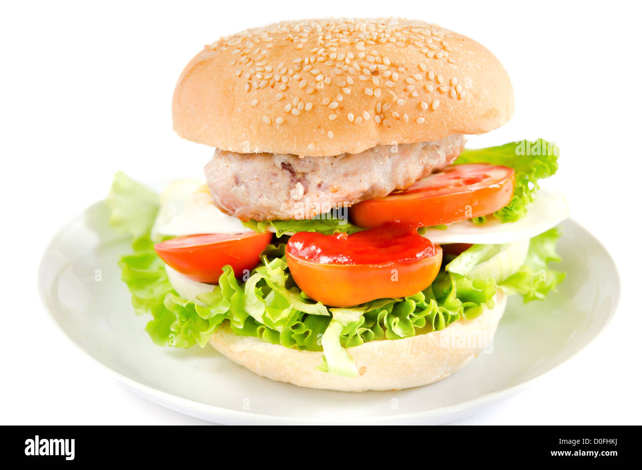 a burger served with pork and salad on dish Stock Photo