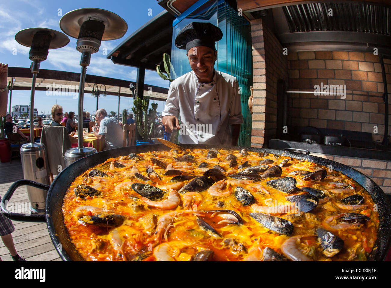 Giant seafood Paella being prepared by a chef in Spanish Restaurant in