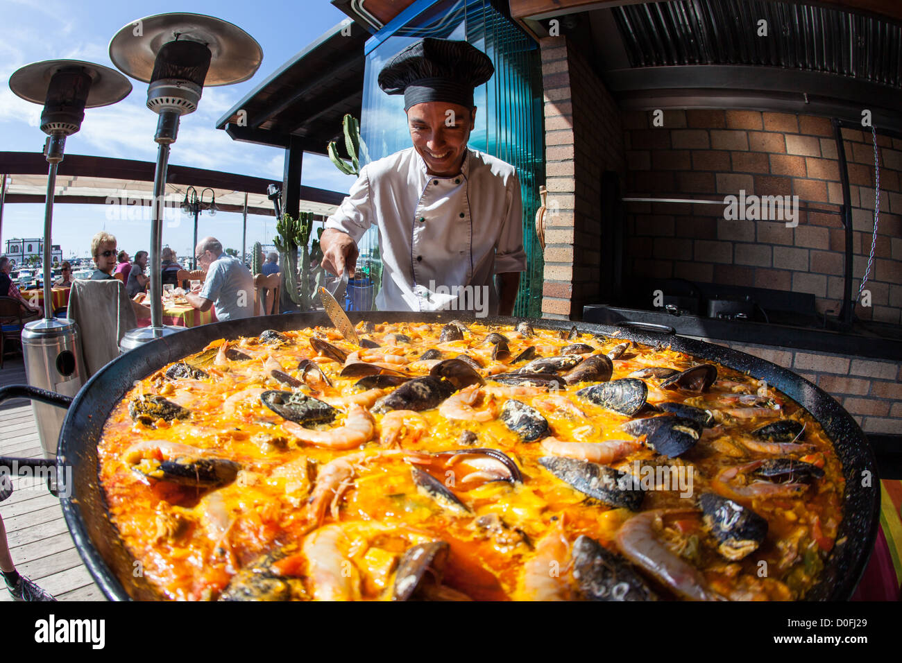 Giant seafood Paella being prepared by a chef in Spanish Restaurant in Playa Blanca, Lanzarote. Canary Islands Stock Photo