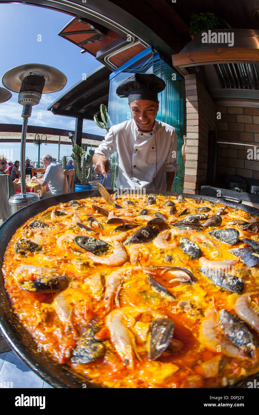 Giant seafood Paella being prepared by a chef in Spanish