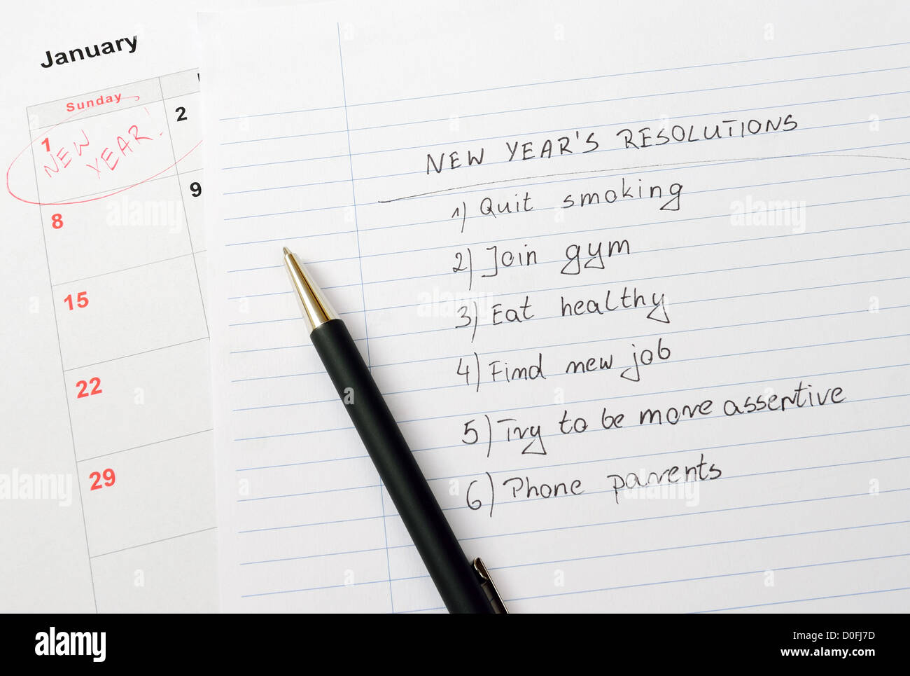 New Year's resolutions listed in notepad Stock Photo