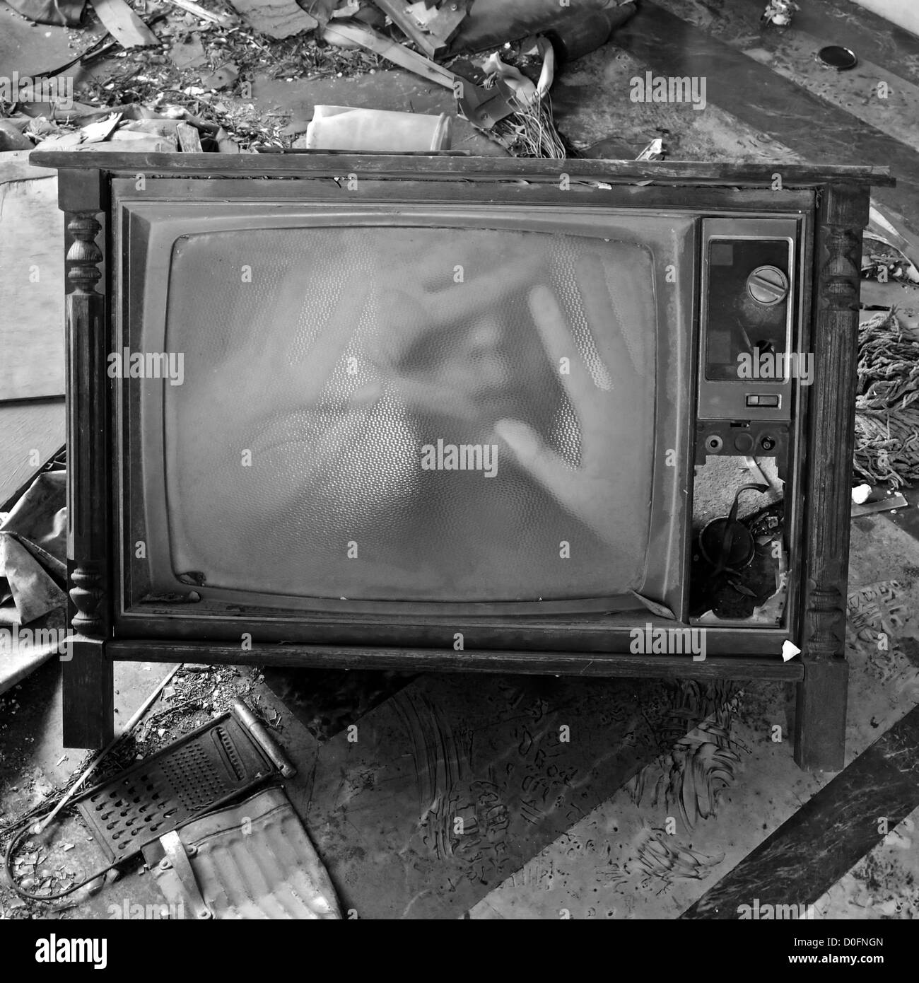 A ghostly figure appears on the flickering screen of an old tv set. Haunted house. Stock Photo
