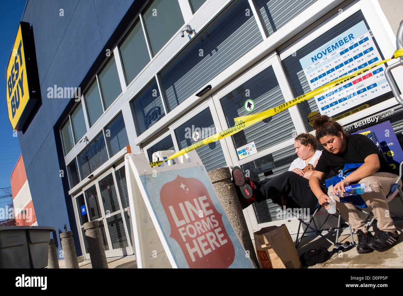 Shoppers lined up outside of a Best Buy store for Black Friday deals.  Stock Photo