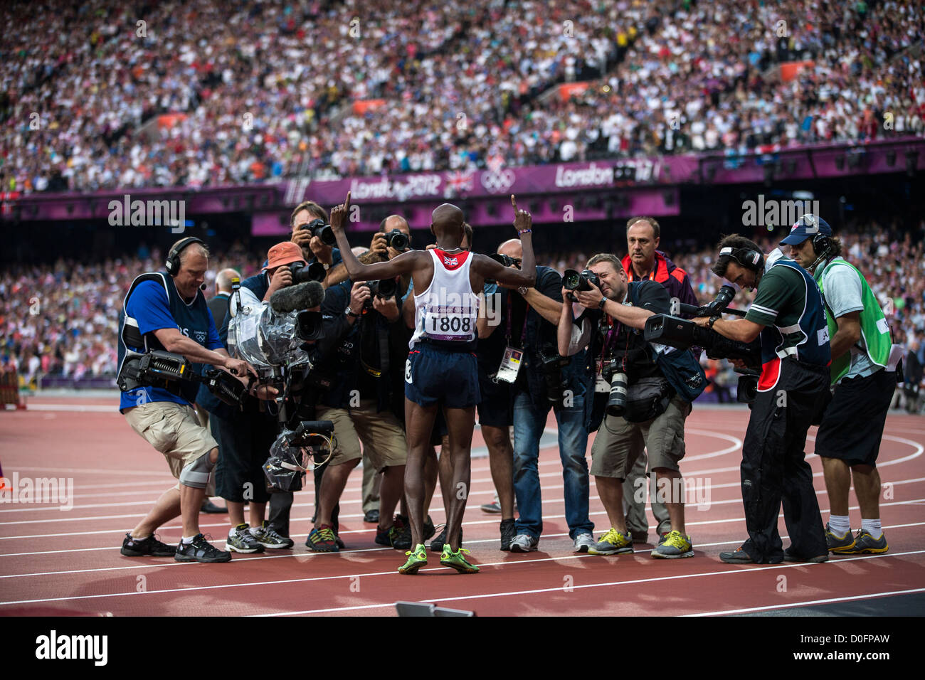 Mohamed Farah (GBR) poses for photographers after winning the gold medal n the Men's 5000m at t he Olympic Summer Games Stock Photo