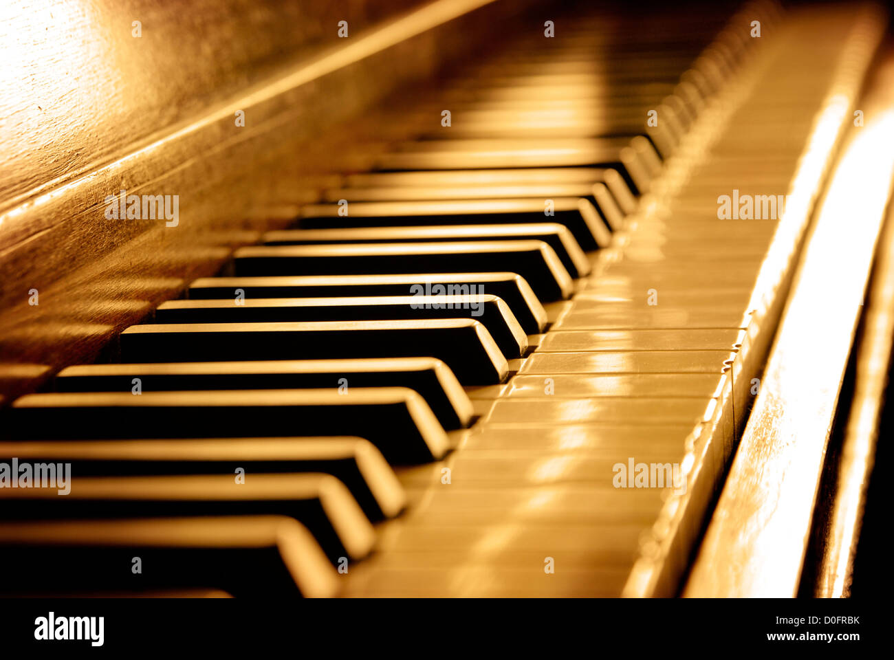 Closeup of black and white piano keys and wood grain with sepia tone Stock Photo