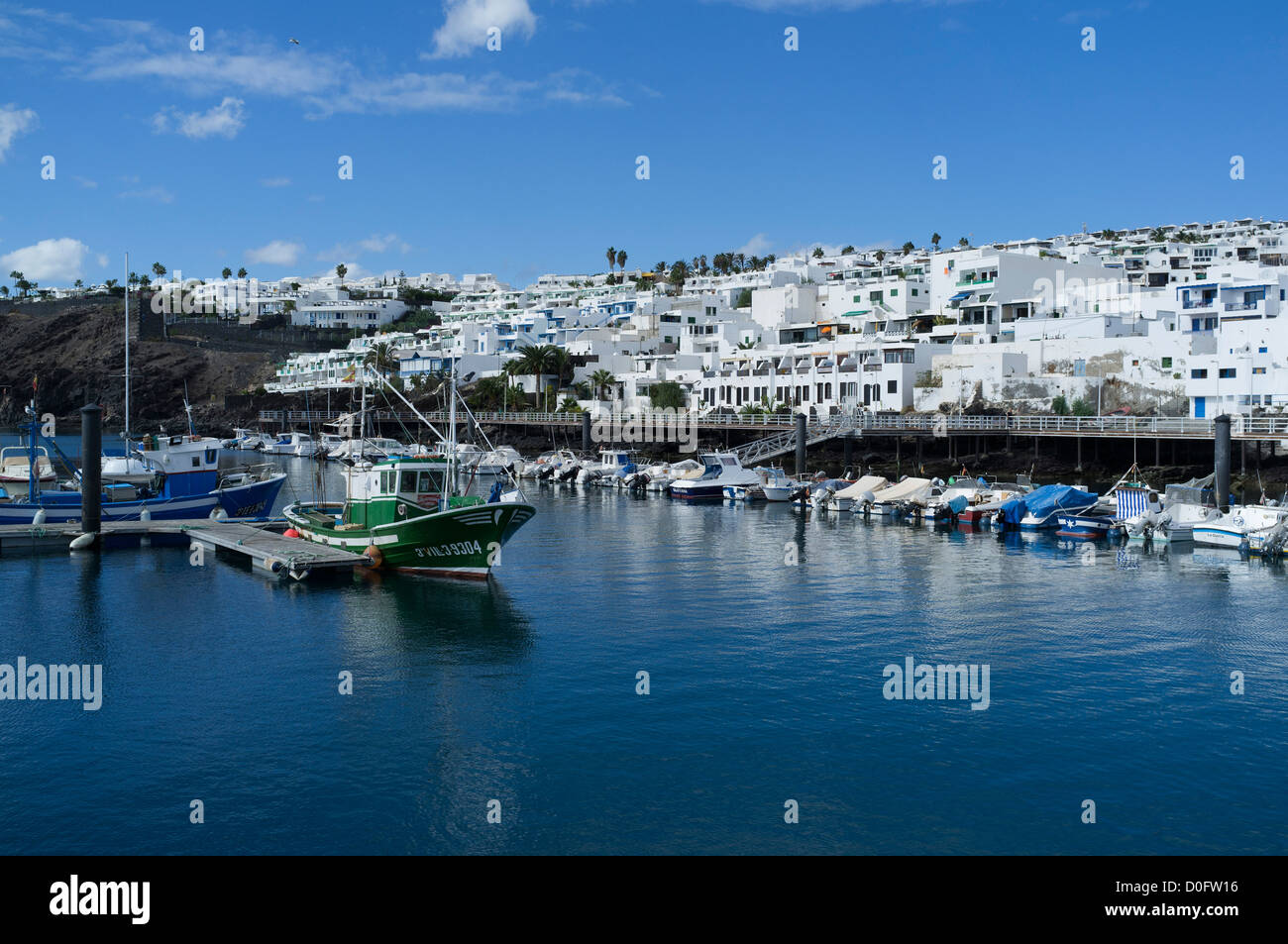 dh Old Harbour PUERTO DEL CARMEN LANZAROTE Fishing boats alongside jetty old town harbour marina boat Stock Photo