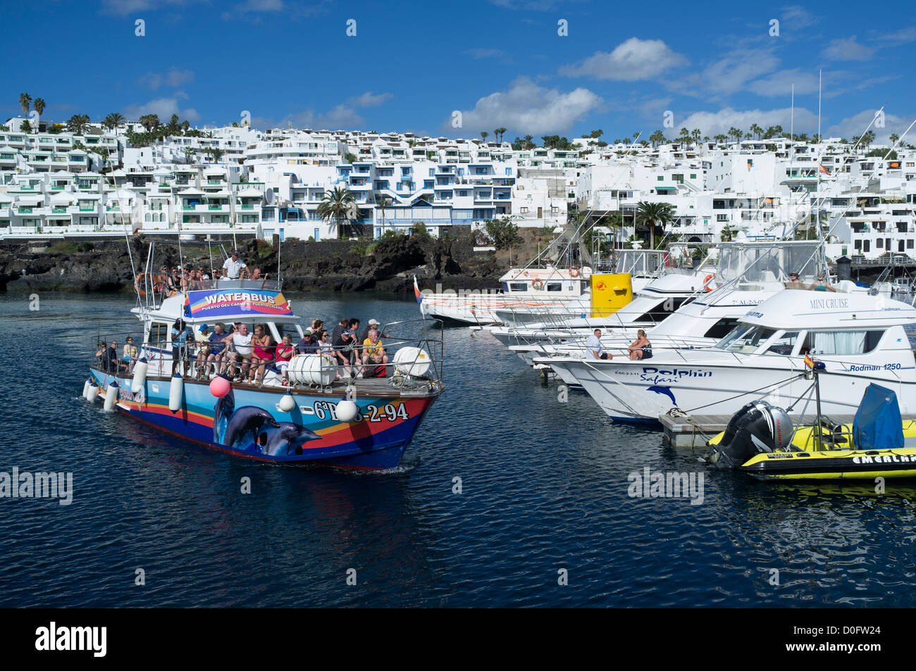 dh Harbour PUERTO DEL CARMEN LANZAROTE colourful ferry trip harbour marina pleasure boats trips boat holiday Stock Photo