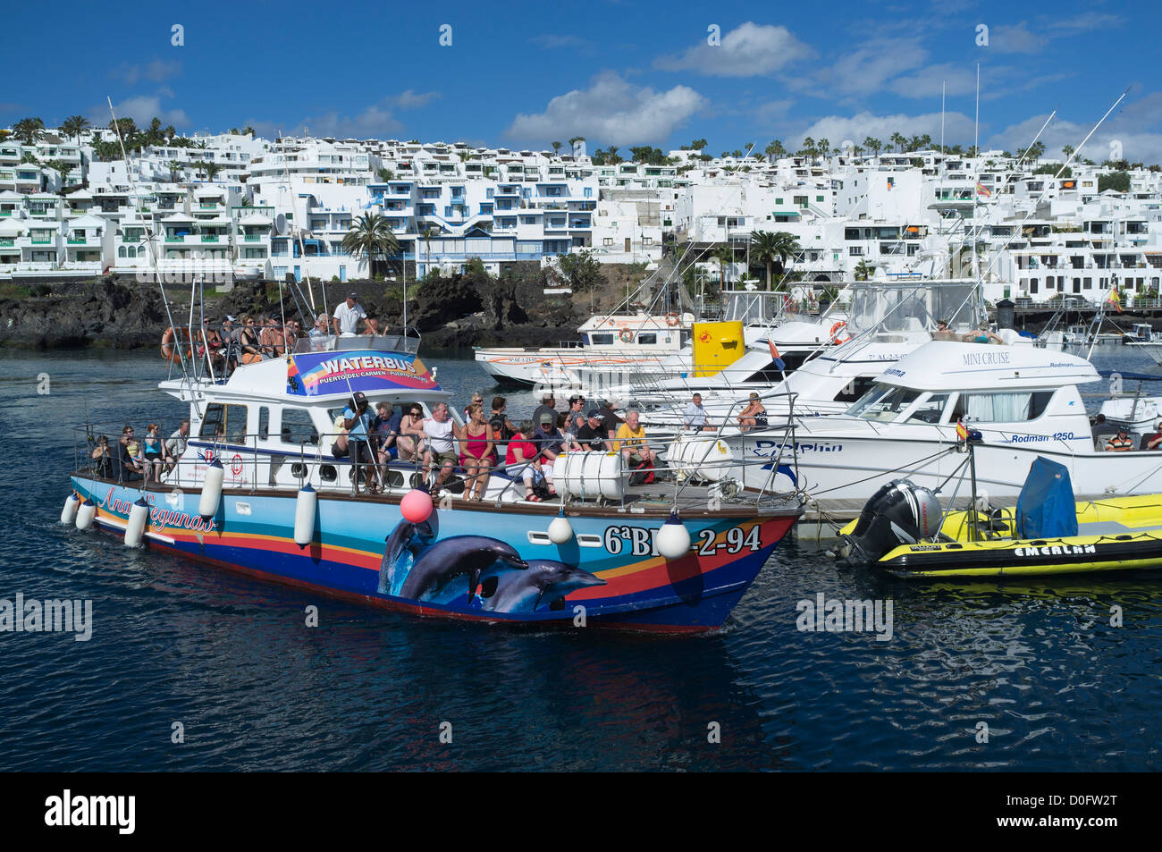 dh Harbour PUERTO DEL CARMEN LANZAROTE colourful ferry trip marina pleasure  boats holiday trips boat tourists Stock Photo - Alamy