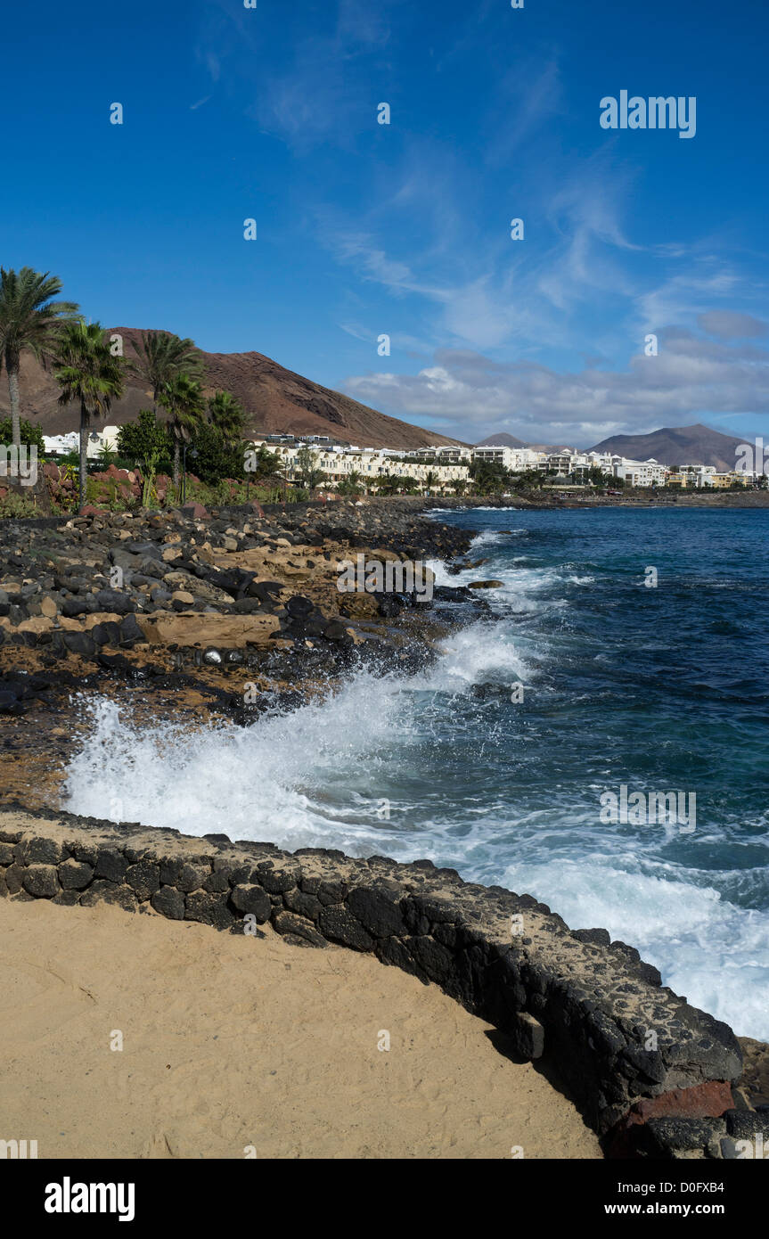 dh  PLAYA BLANCA LANZAROTE Atlantic coast sea waves crashing ashore holiday resort town wave Stock Photo