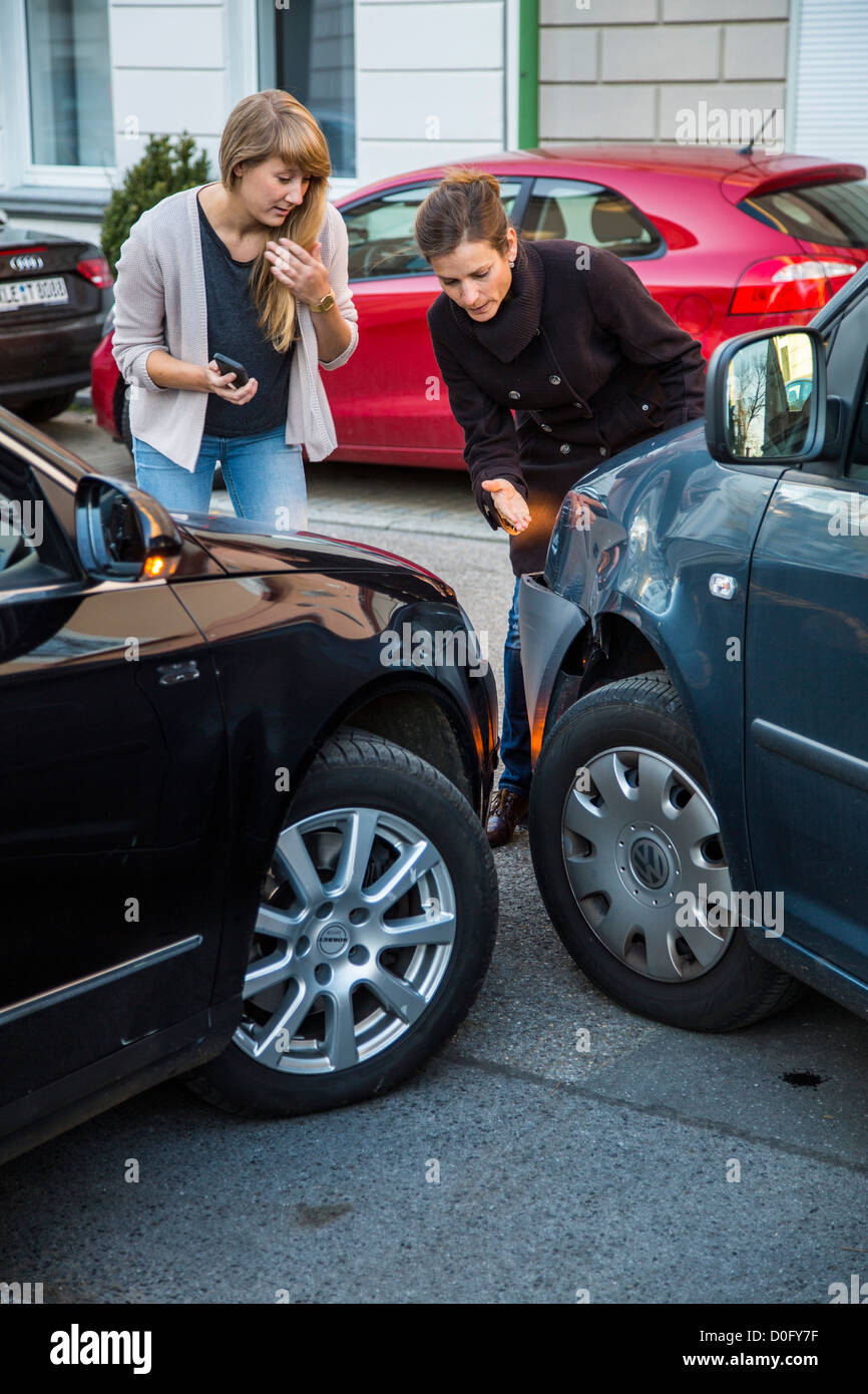 Car accident with minor damage. To woman discus the reason of the car ...