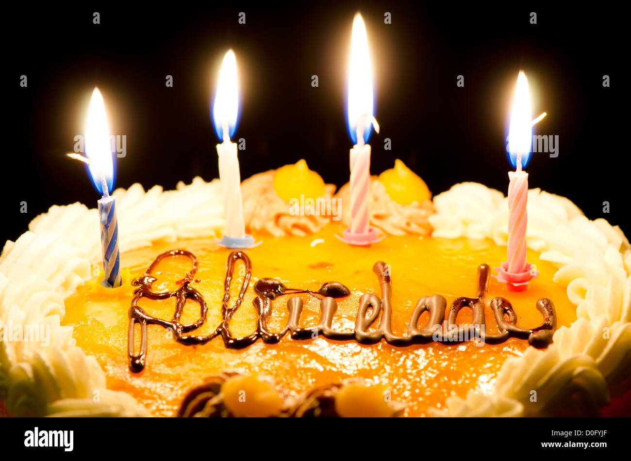 Birthday Candles on Cake in ambient light Stock Photo - Alamy