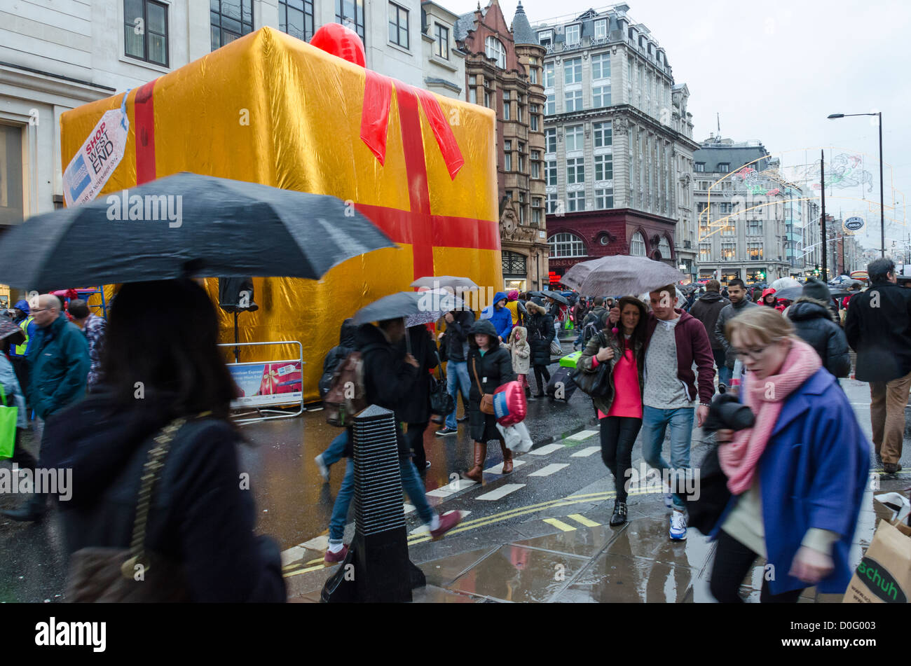 Christmas Shoppers in the rain on Oxford Street, London during the West End Shopping weekend with the road closed to traffic. Stock Photo