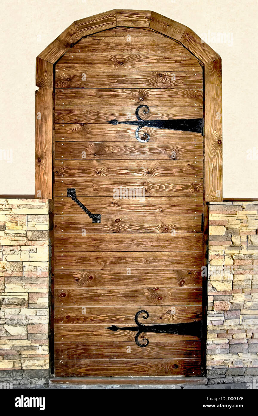 Brown Wooden Door With Black Metal Handles And Hinges On The Stock